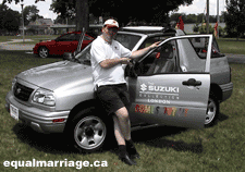 Joe Varnell standing beside the grand marshal vehicle used in the parade. (Photo by equalmarriage.ca, 2003)