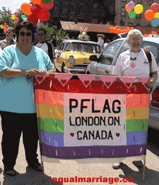 Brenda Boswell Simpson (left), marched in her first Pride parade, helping to support a banner from the London chapter of PFLAG. (Photo by equalmarriage.ca, 2003)
