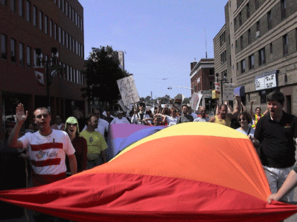 Marching in downtown Sudbury, carrying the flag  - Joe Varnell, 2nd from right (Photo by equalmarriage.ca, 2002)