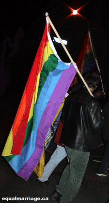A marcher with rainbow flag (Photo by equalmarriage.ca, 2003)