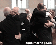 The wedding party hugs in celebration (Photo by equalmarriage.ca, 2003)