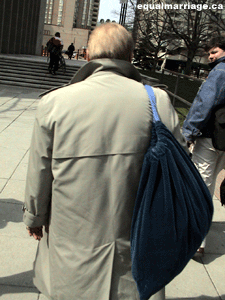 Douglas Elliott carrying his lawyer's bag away from the courthouse - Joe Varnell can be seen looking on (Photo by equalmarriage.ca, 2003)