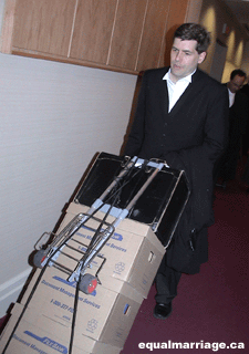 Trent Morris returning to the offices of MEK with some of the volumes of evidence that was used in an effort to obtain in our freedom to marry (Photo by equalmarriage.ca, 2003)